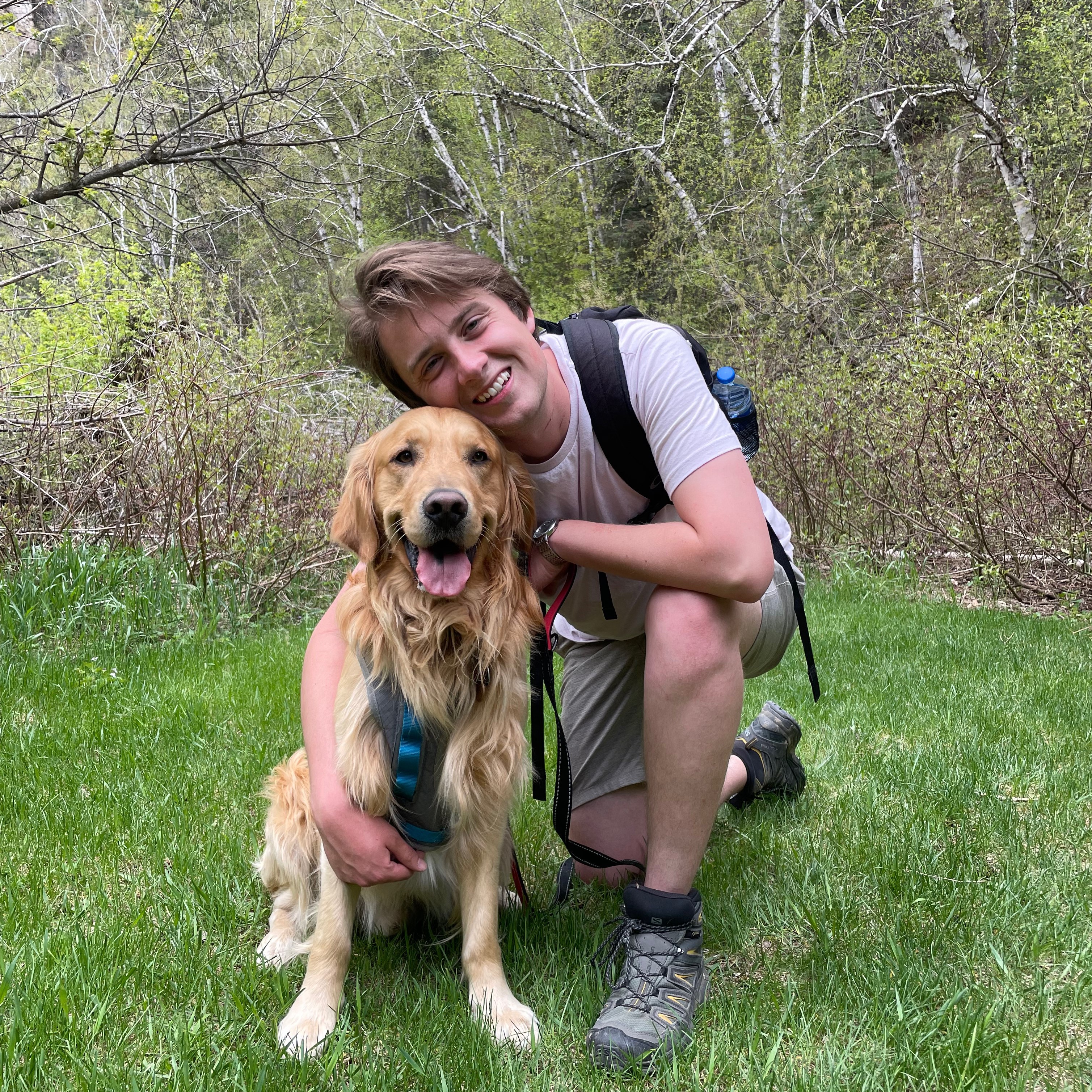 Picture of Tyler Stewert with a golden retriever