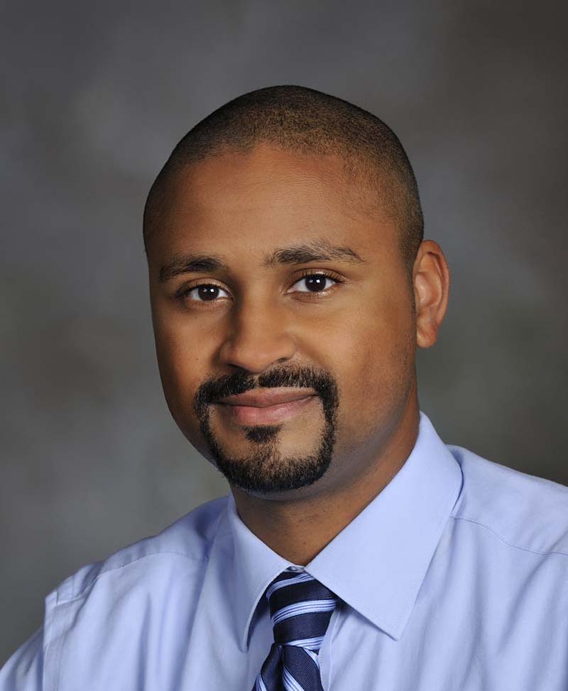 Professional headshot of Dr, Warren Milteer, Jr. in front of a gray background