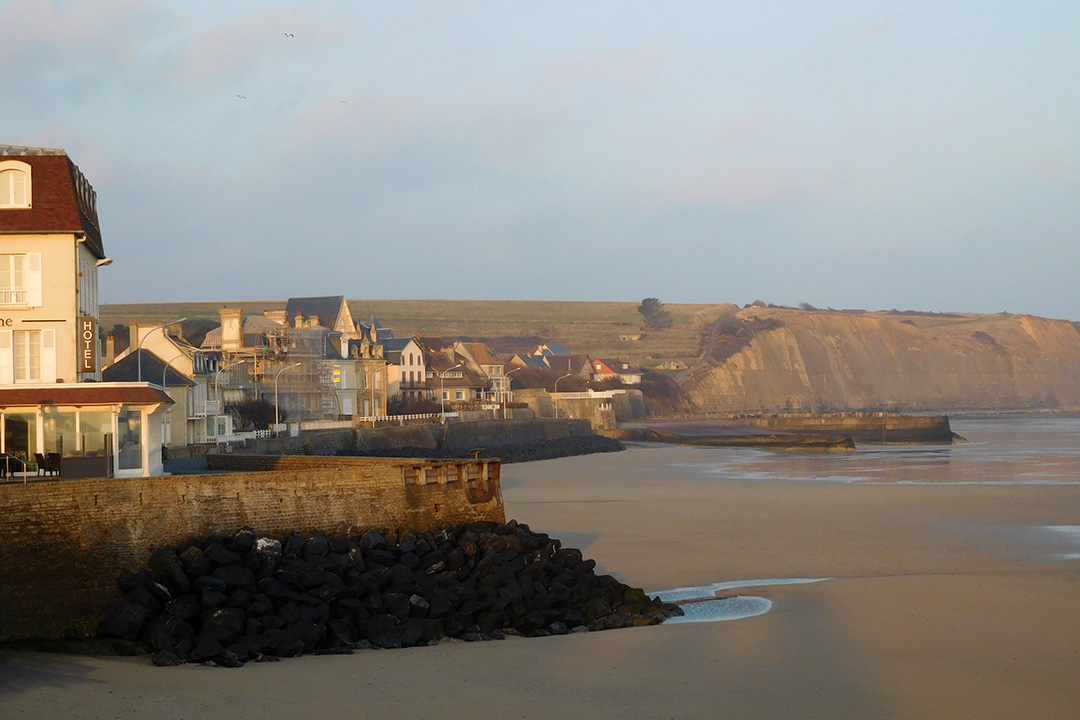 Image of a hotel and row of houses along a beach in France
