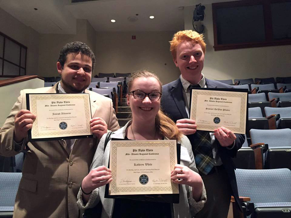 Joe Albanese, Kate White, and Sam Pfister hold up their awards from the 2017 Phi Alpha Theta Regional Conference.