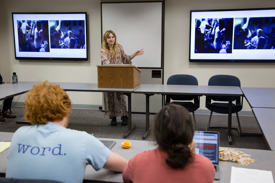 Undergraduate Miranda van der Meulen presenting her thesis to a room of students at the undergraduate symposium