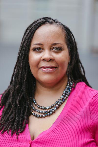 Headshot of Erin Chapman on a gray background