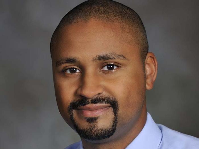 Professional headshot of Dr, Warren Milteer, Jr. in front of a gray background